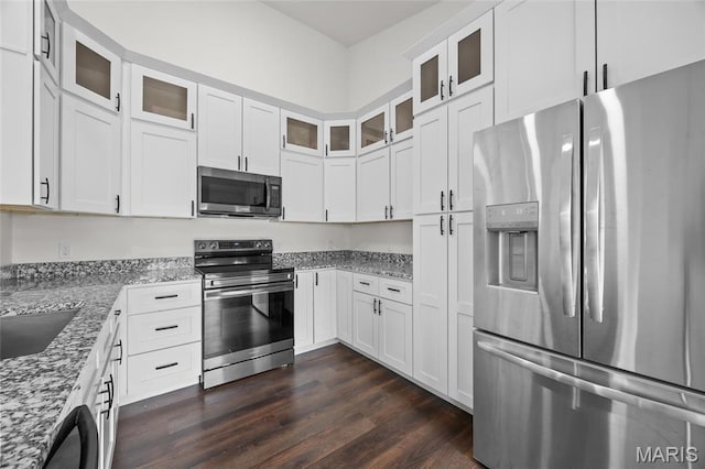 764 Red Clover Dr, Cedar Hill, MO 63016 - kitchen with stainless steel appliances, dark wood finished floors, light stone counters, and white cabinetry