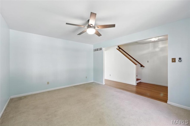 6144 Misty Meadow Dr, House Springs, MO 63051 - unfurnished living room with light colored carpet, a ceiling fan, and stairway