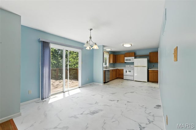 6144 Misty Meadow Dr, House Springs, MO 63051 - kitchen featuring white appliances, brown cabinetry, light countertops, hanging light fixtures, and a chandelier