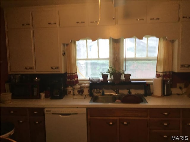 504 S Hickory St S, Cuba, MO 65453 - kitchen featuring white dishwasher, a sink, light countertops, and white cabinets