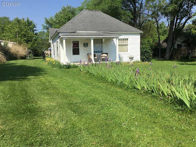 504 S Hickory St S, Cuba, MO 65453 - back of house with covered porch, a yard, and roof with shingles