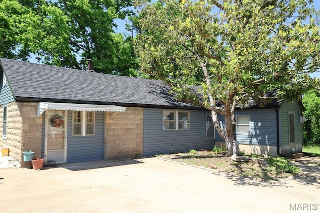 5501 Dober Ln, Saint Louis, MO 63129 - view of front of property with a shingled roof, a patio area, and brick siding