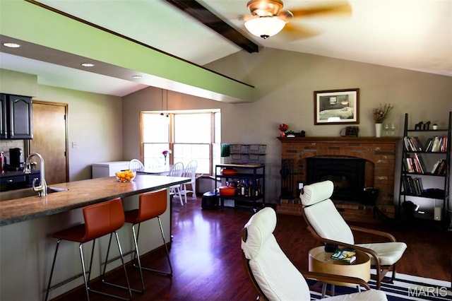 5501 Dober Ln, Saint Louis, MO 63129 - living area featuring dark wood-style floors, a ceiling fan, and a brick fireplace