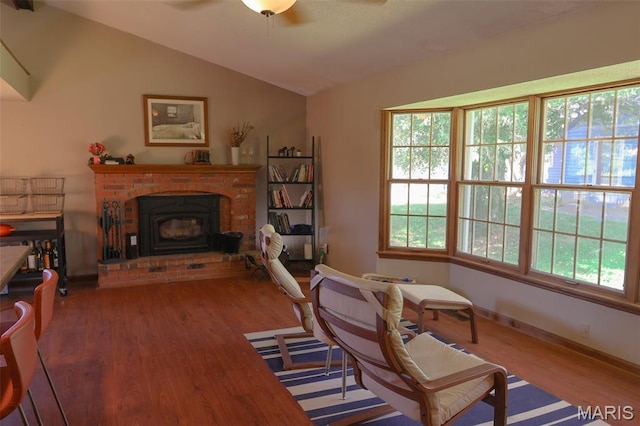 5501 Dober Ln, Saint Louis, MO 63129 - sitting room with wood finished floors, vaulted ceiling, ceiling fan, a brick fireplace, and baseboards