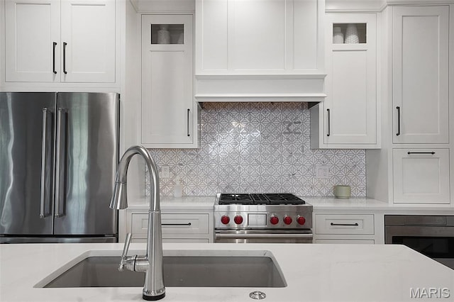 385 E Clinton Pl, Saint Louis, MO 63122 - kitchen featuring premium appliances, white cabinets, a sink, and glass insert cabinets