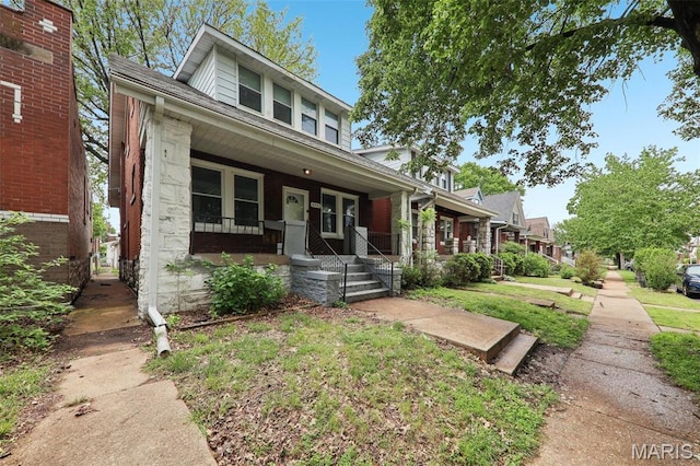 4942 Bonita Ave, Saint Louis, MO 63109 - view of front of house featuring covered porch, stone siding, a front yard, and roof with shingles