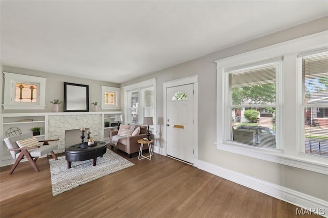 4942 Bonita Ave, Saint Louis, MO 63109 - living room with wood finished floors, baseboards, and a fireplace