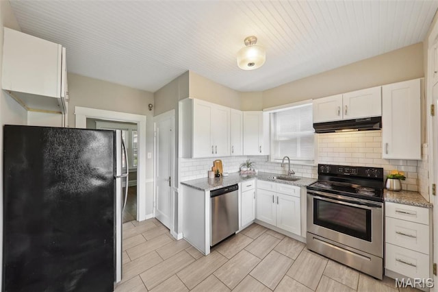 4942 Bonita Ave, Saint Louis, MO 63109 - kitchen with appliances with stainless steel finishes, under cabinet range hood, decorative backsplash, and a sink