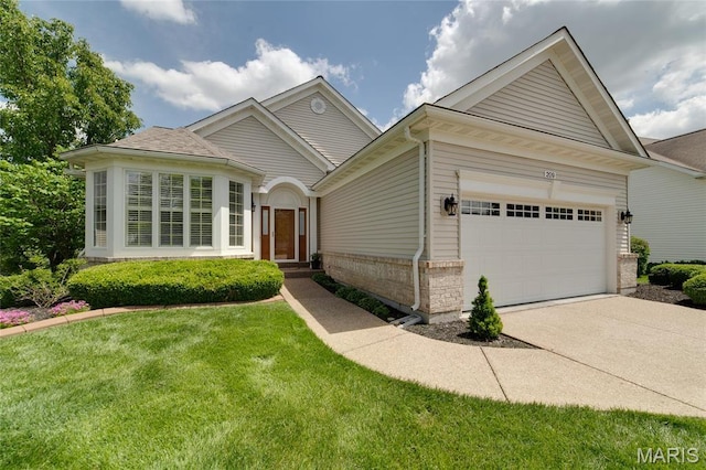 view of front of house with brick siding, driveway, a garage, and a front yard