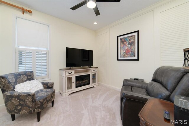 carpeted living area featuring baseboards, ceiling fan, and recessed lighting