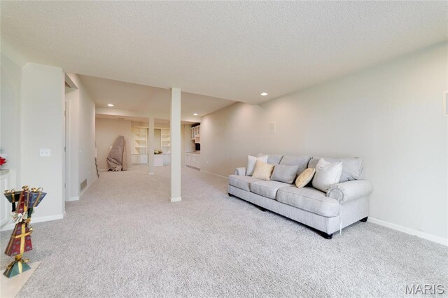 living room with light carpet, baseboards, recessed lighting, and a textured ceiling