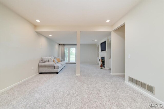 living area featuring light carpet, recessed lighting, baseboards, and a fireplace