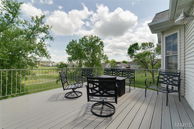 wooden terrace featuring outdoor dining space
