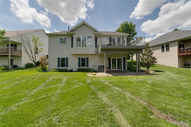 back of house featuring a yard and french doors