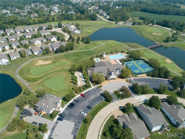 aerial perspective of suburban area featuring a large body of water and a golf club