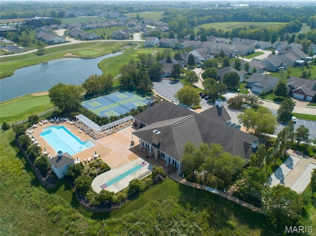 aerial perspective of suburban area with a pool area, a large body of water, and a golf course