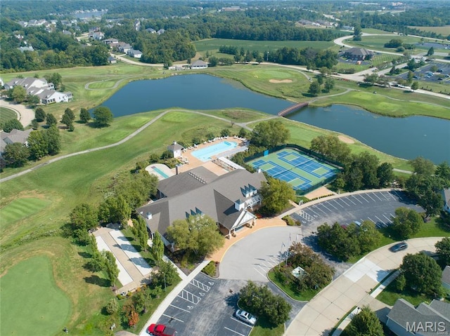 drone / aerial view of a nearby body of water and a golf club
