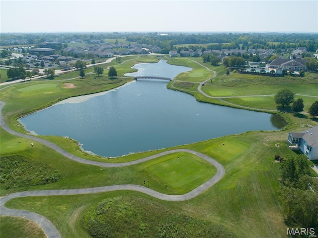 aerial view of property's location with a large body of water, a golf course, and nearby suburban area