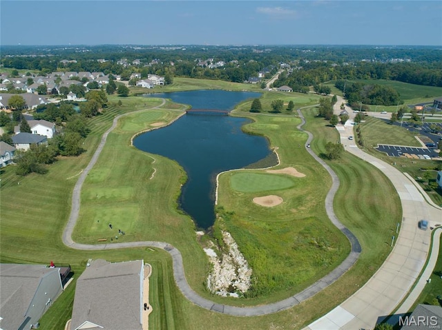 aerial view of property's location featuring a nearby body of water and nearby suburban area
