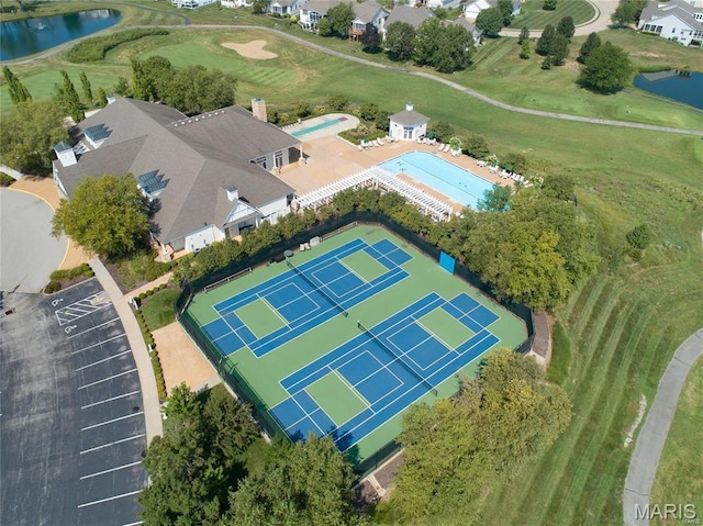 aerial view of property's location featuring a nearby body of water and a golf course