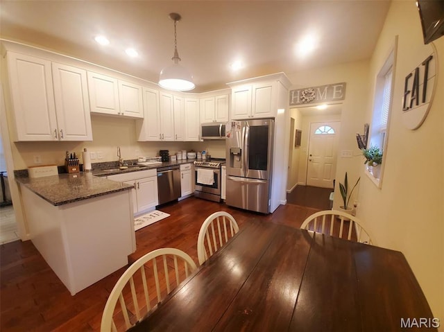 511 Grant St, Canton, MO 63435 - kitchen with appliances with stainless steel finishes, a sink, white cabinets, dark wood finished floors, and recessed lighting
