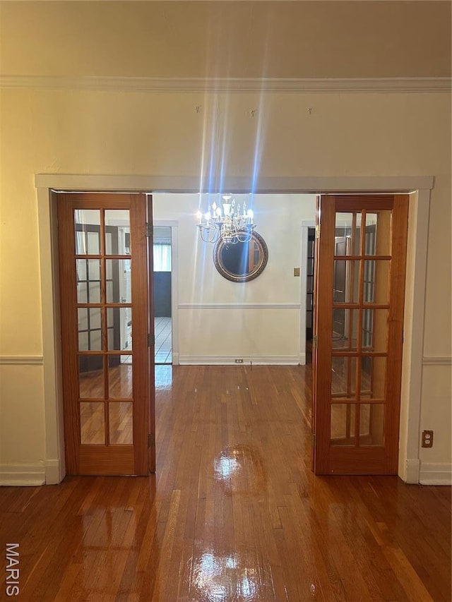 719 Leland Ave, Saint Louis, MO 63130 - hallway with a chandelier, hardwood / wood-style flooring, baseboards, and crown molding
