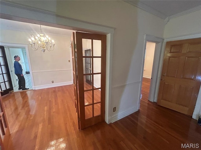 719 Leland Ave, Saint Louis, MO 63130 - foyer entrance with ornamental molding, wood finished floors, a chandelier, and baseboards