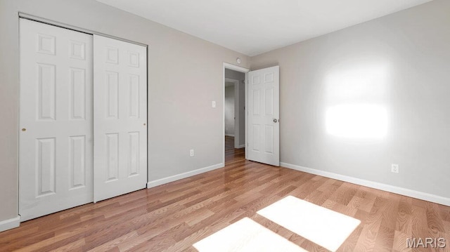 939 Vosholl Ave, Warrenton, MO 63383 - unfurnished bedroom with light wood-style flooring, baseboards, and a closet