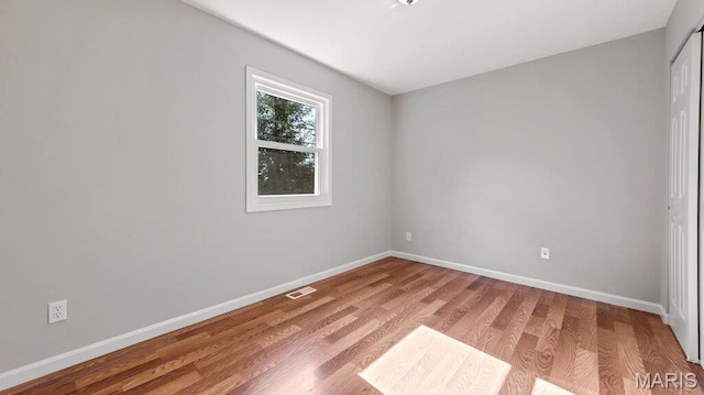 939 Vosholl Ave, Warrenton, MO 63383 - unfurnished bedroom with baseboards, light wood-style flooring, and a closet