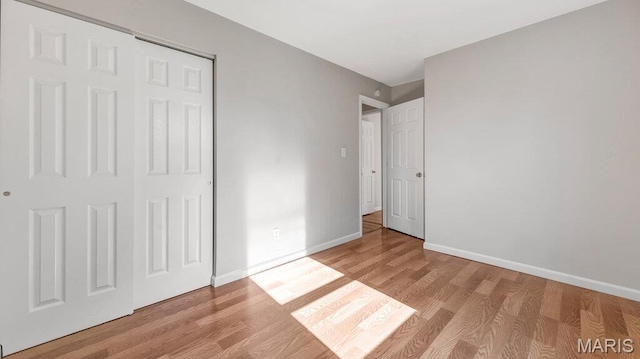 939 Vosholl Ave, Warrenton, MO 63383 - unfurnished bedroom with light wood-type flooring, baseboards, and a closet