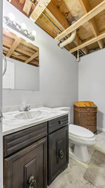 939 Vosholl Ave, Warrenton, MO 63383 - bathroom with vanity, toilet, and unfinished concrete flooring