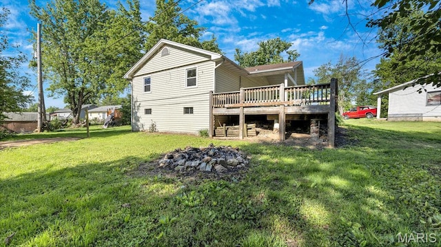 939 Vosholl Ave, Warrenton, MO 63383 - back of house with a deck, a yard, and a fire pit