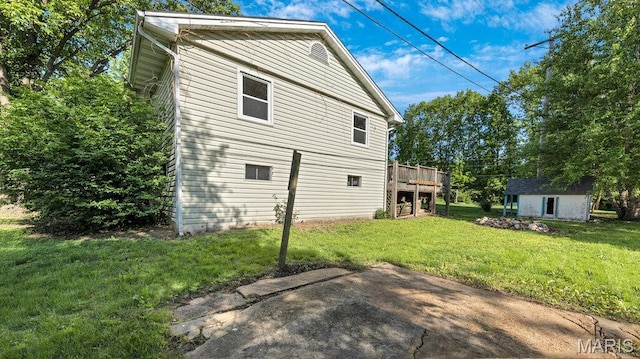 939 Vosholl Ave, Warrenton, MO 63383 - rear view of property featuring an outbuilding, a lawn, and a wooden deck
