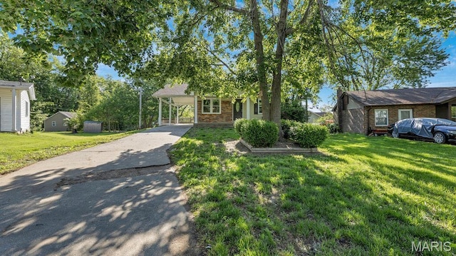 939 Vosholl Ave, Warrenton, MO 63383 - view of front of property featuring brick siding, concrete driveway, a front yard, and a carport