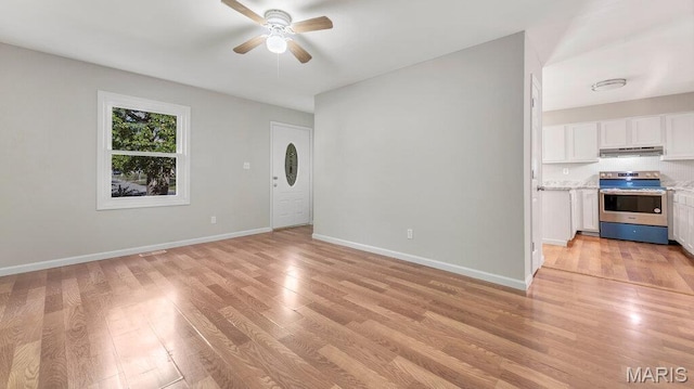 939 Vosholl Ave, Warrenton, MO 63383 - unfurnished living room featuring ceiling fan, light wood-type flooring, and baseboards