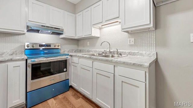 939 Vosholl Ave, Warrenton, MO 63383 - kitchen featuring a sink, stainless steel electric stove, under cabinet range hood, white cabinets, and light countertops