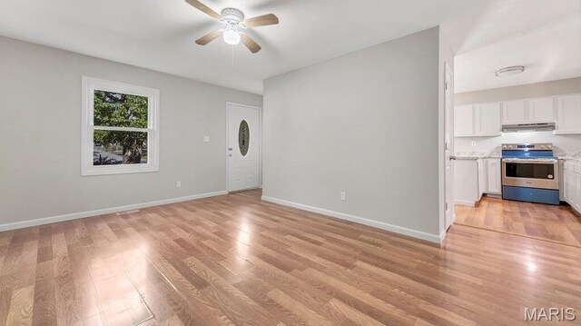939 Vosholl Ave, Warrenton, MO 63383 - unfurnished living room with ceiling fan, light wood-type flooring, and baseboards