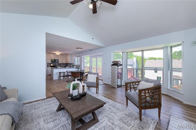 200 Kylewood Ct, Ballwin, MO 63021 - living area featuring a ceiling fan, light wood-type flooring, baseboards, and high vaulted ceiling