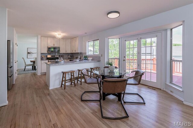 200 Kylewood Ct, Ballwin, MO 63021 - dining area featuring light wood-style floors and baseboards