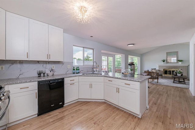 200 Kylewood Ct, Ballwin, MO 63021 - kitchen with dishwasher, a peninsula, a sink, white cabinetry, and vaulted ceiling