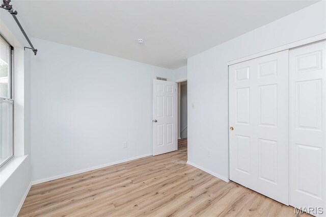 200 Kylewood Ct, Ballwin, MO 63021 - unfurnished bedroom featuring light wood finished floors, baseboards, and a closet