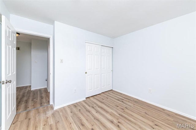 200 Kylewood Ct, Ballwin, MO 63021 - unfurnished bedroom with light wood-type flooring, baseboards, and a closet