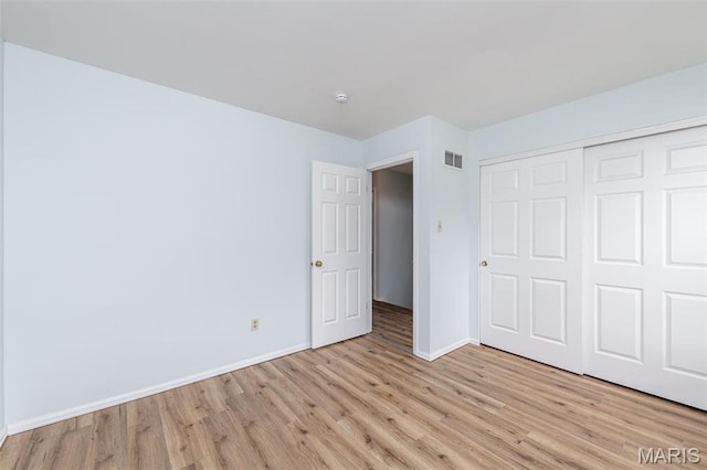 200 Kylewood Ct, Ballwin, MO 63021 - unfurnished bedroom featuring light wood-style floors, baseboards, and a closet