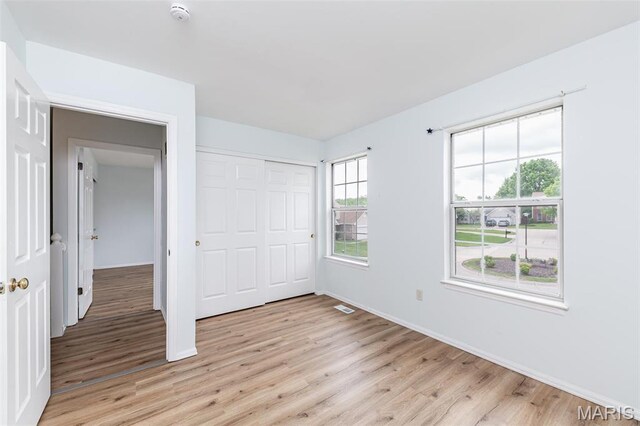 200 Kylewood Ct, Ballwin, MO 63021 - unfurnished bedroom featuring light wood finished floors, baseboards, and a closet
