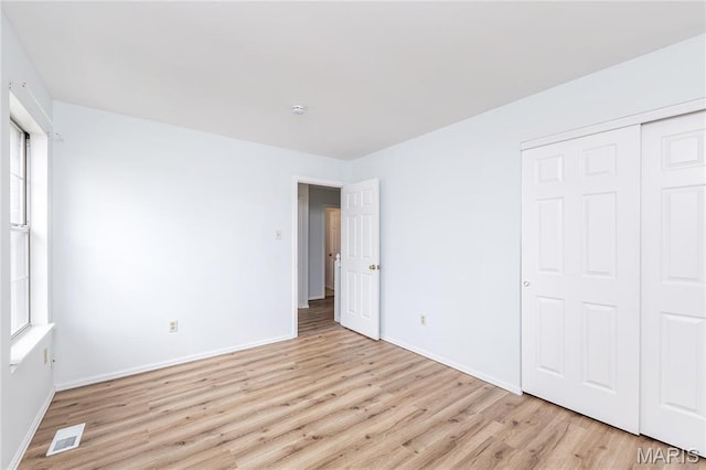 200 Kylewood Ct, Ballwin, MO 63021 - unfurnished bedroom with light wood-type flooring, baseboards, and a closet