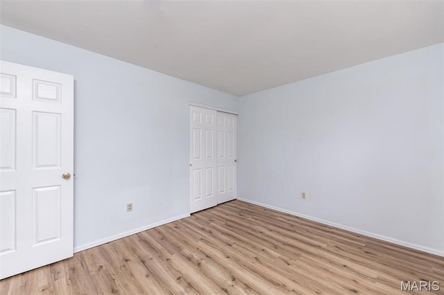 200 Kylewood Ct, Ballwin, MO 63021 - unfurnished bedroom featuring light wood-style flooring, baseboards, and a closet