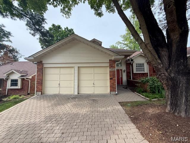 12910 Autumn View Dr, Saint Louis, MO 63146 - ranch-style home with brick siding, an attached garage, and decorative driveway