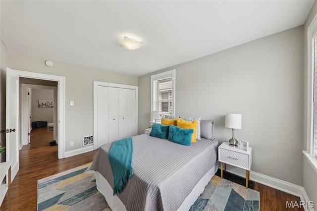 5909 Hampton Ave, Saint Louis, MO 63109 - bedroom with baseboards, wood finished floors, and a closet
