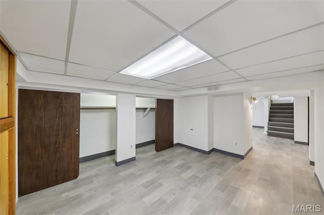 5909 Hampton Ave, Saint Louis, MO 63109 - finished below grade area featuring stairway, light wood finished floors, baseboards, and a drop ceiling