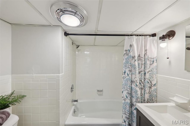 5909 Hampton Ave, Saint Louis, MO 63109 - full bath featuring tile walls, shower / bath combo with shower curtain, vanity, toilet, and a wainscoted wall